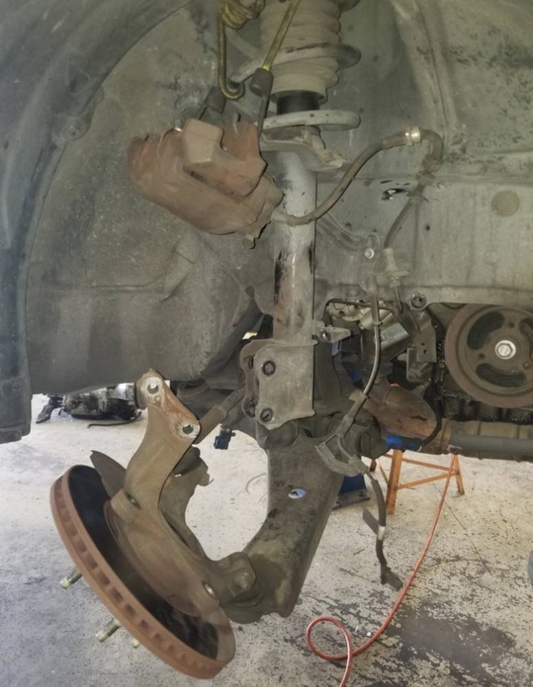 Strut and knuckle separated for front suspension work
